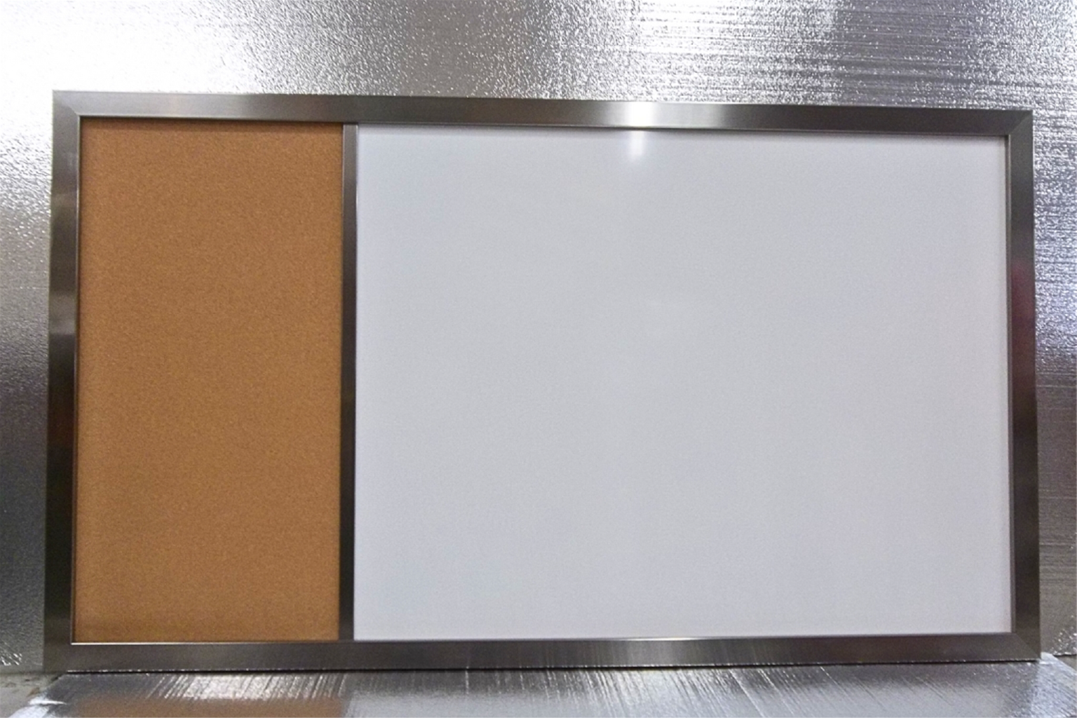 This board features a sleek metal frame, adding a modern and durable touch.